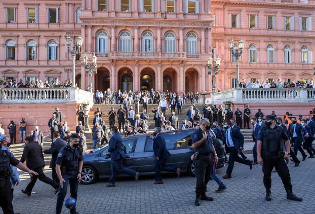 The hearse carrying the casket of soccer legend Diego Maradona drives past the presidential palace Casa Rosada, in Buenos Aires