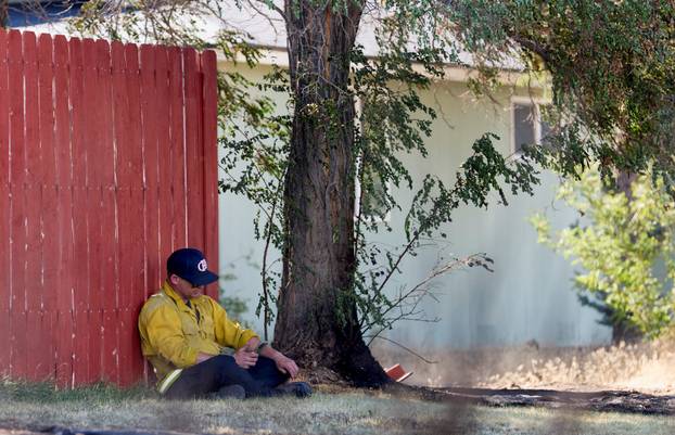 A firefighter rests in the shade while battling Hawk Fire in Reno