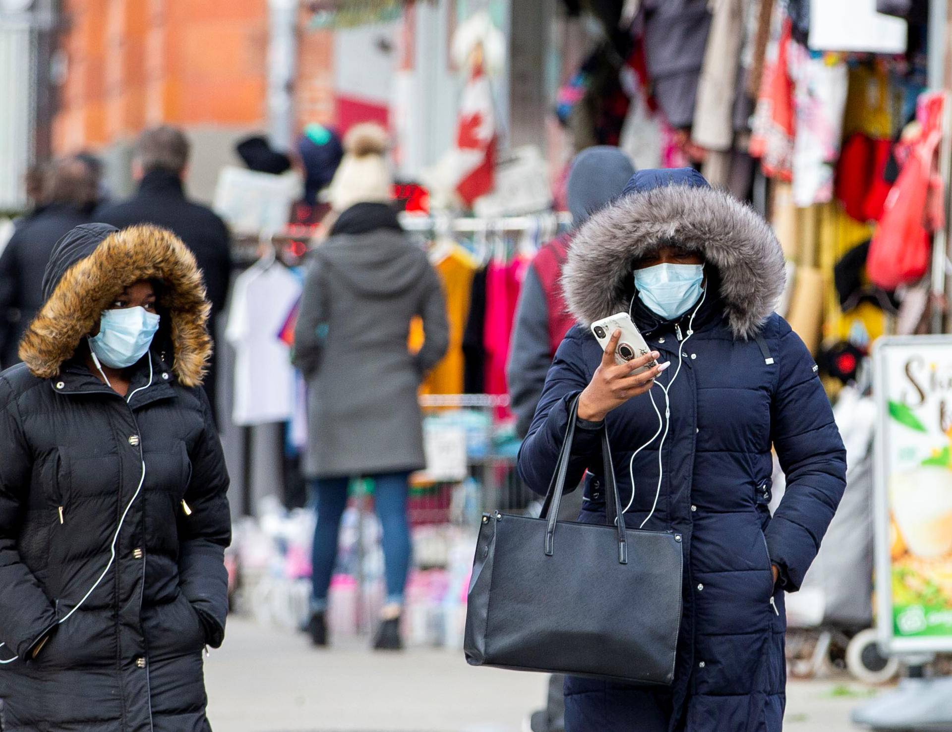 Pedestrians walk in the Chinatown district of downtown Toronto