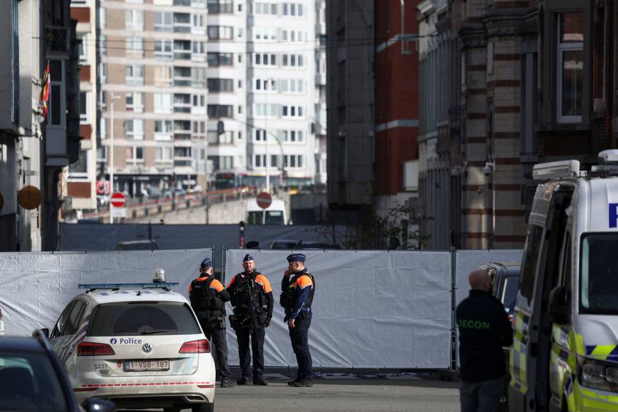 Police secure the site of a synagogue damaged by an explosion in Liege