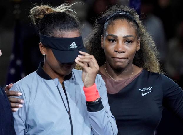 FILE PHOTO: Naomi Osaka of Japan cries as Serena Williams of the USA comforts her in New York