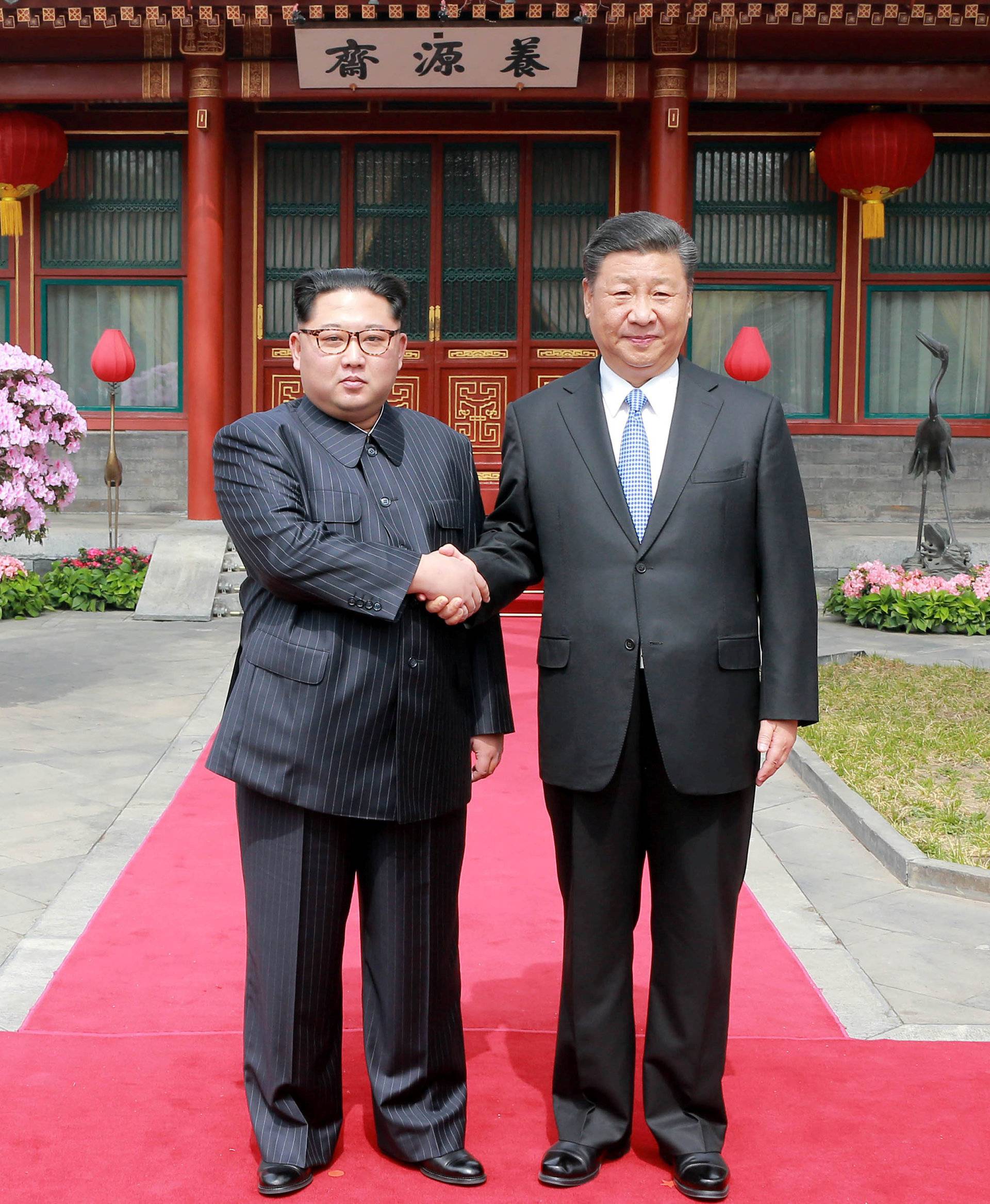 North Korean leader Kim Jong Un shakes hands with Chinese President Xi Jinping