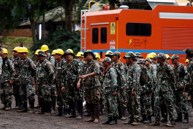 Rescue workers line up near Tham Luang cave complex, as members of an under-16 soccer team and their coach have been found alive according to a local media report, in the northern province of Chiang Rai