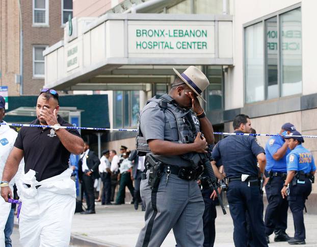 Police officers patrol the scene after an incident in which a gunman fired shots inside the Bronx-Lebanon Hospital in New York City
