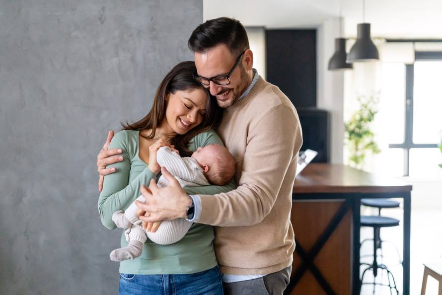 Peaceful,Young,Married,Couple,Enjoying,Being,Family,,Parents,,Holding,New