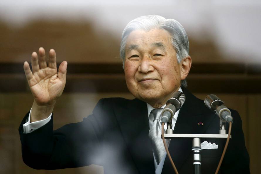 Japan's Emperor Akihito's waves to well-wishers at the Imperial Palace in Tokyo