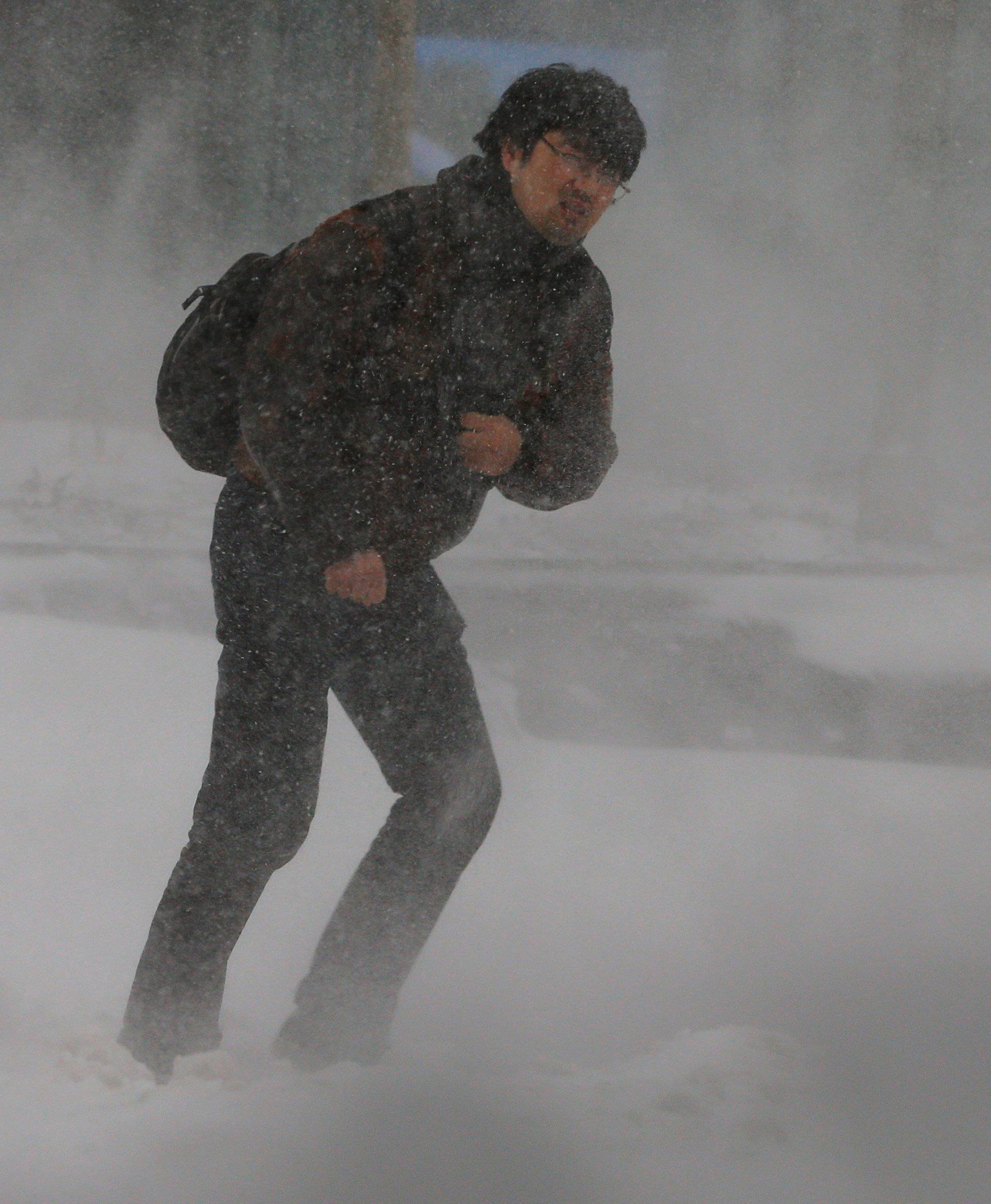 A man walks through Storm Grayson in Boston