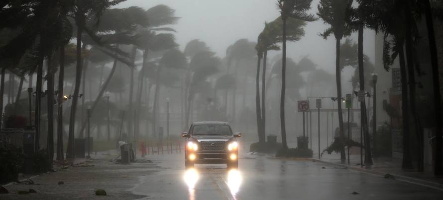 A vehicle drives along Ocean Drive in South Beach as Hurricane Irma arrives at south Florida, in Miami Beach