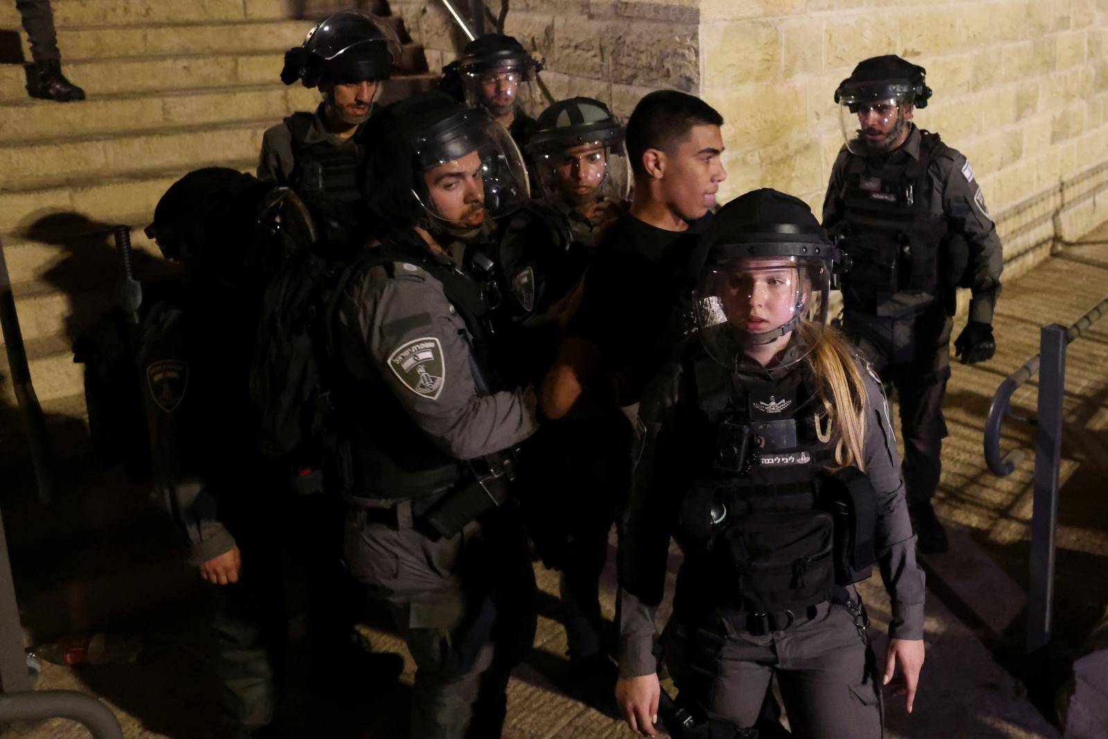 Israeli Border Police force detain a Palestinian protestor during clashes at Damascus Gate by the entrance to Jerusalem's Old City