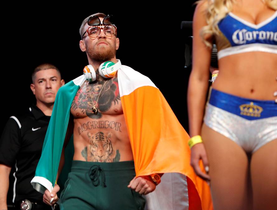 UFC lightweight champion Conor McGregor of Ireland arrives on stage for his official weigh-in at T-Mobile Arena in Las Vegas