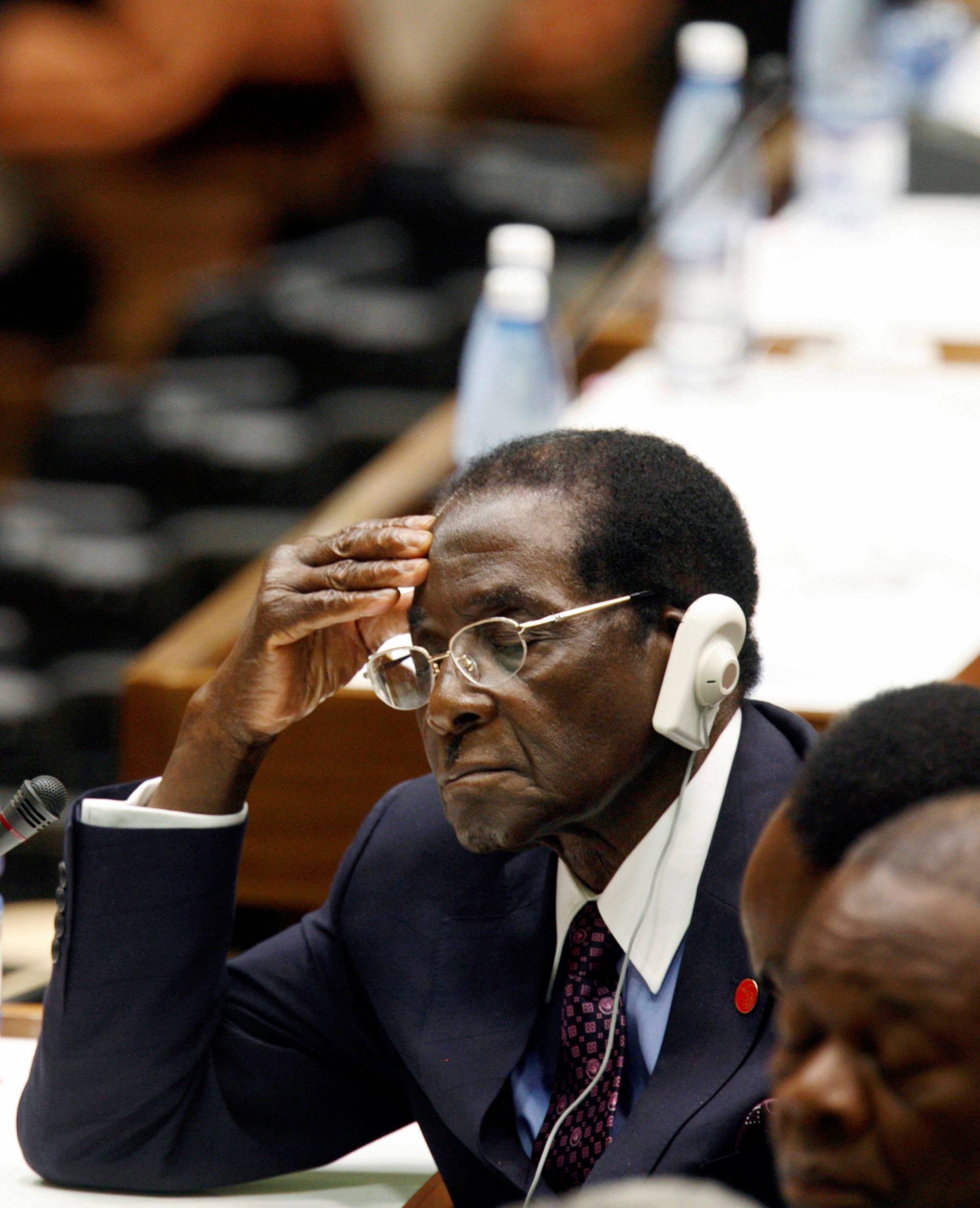 FILE PHOTO -  File photo of Zimbabwe's President Robert Mugabe closing his eyes as he listens to Castro's closing statement in Havana
