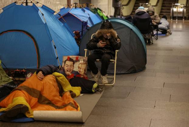 People take shelter inside a metro station during a Russian missile and drone attack in Kyiv