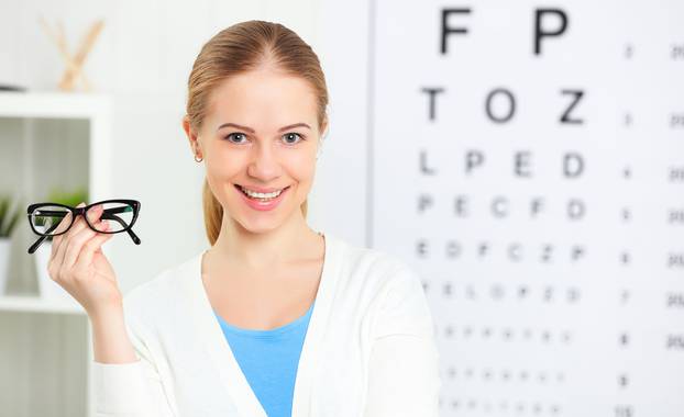 eyesight check. woman with glasses at doctor ophthalmologist optician
