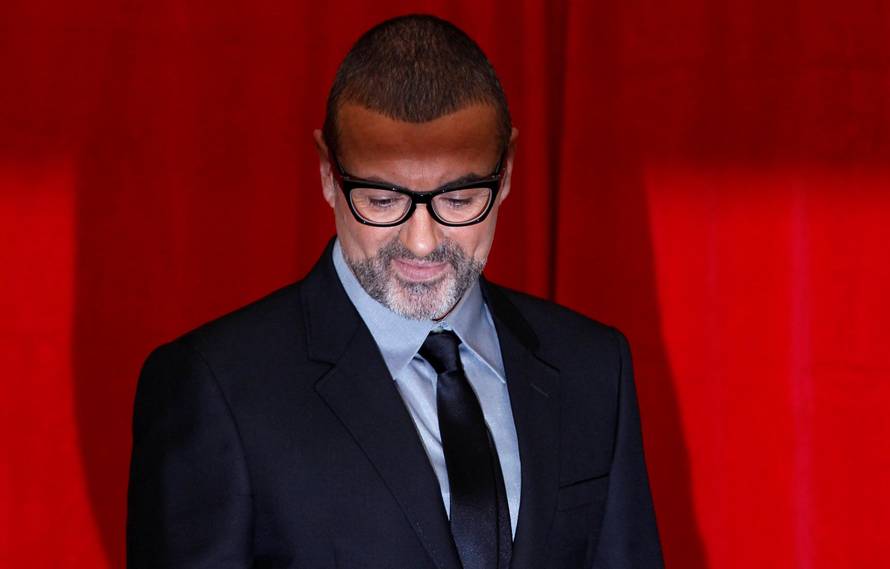 FILE PHOTO British singer George Michael poses for photographers before a news conference at the Royal Opera House in central London