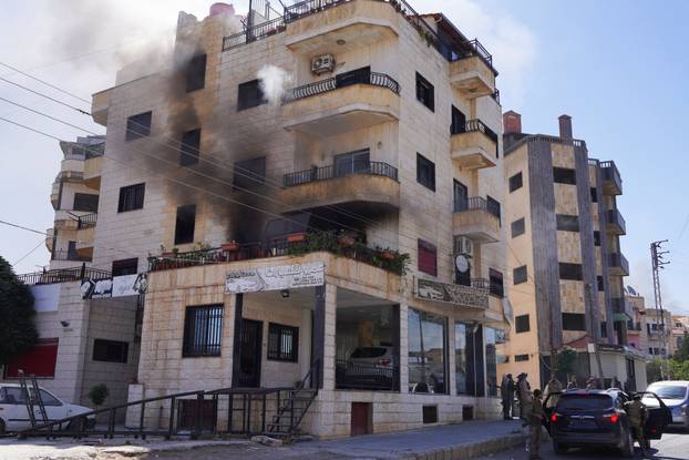 Smoke rises from a building, in Sweida