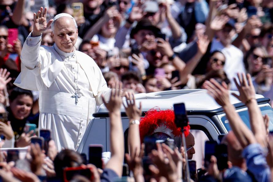 Pope Leo XIV delivers his "Urbi et Orbi" (To the city and the world) message from the main balcony of St. Peter's Basilica