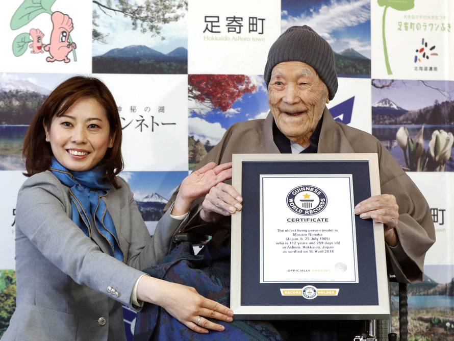 Japanese Masazo Nonaka, who was born 112 years and 259 days ago, receives a Guinness World Records certificate naming him the world's oldest man during a ceremony in Ashoro