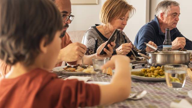 Sad,Family,Having,Meal,Together,But,Ignoring,Each,Other.,Checking