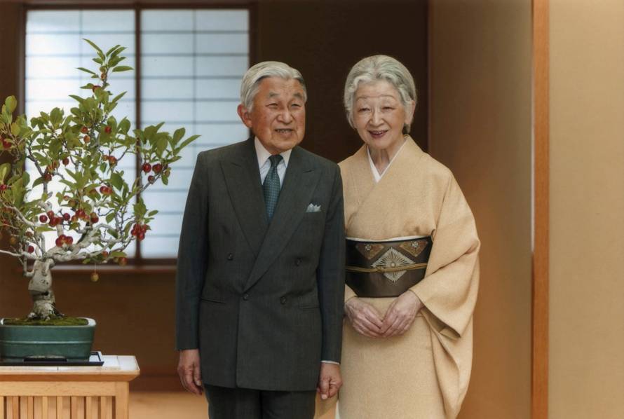 Japan's Emperor Akihito exchanges smiles with Empress Michiko at the Imperial Palace in Tokyo