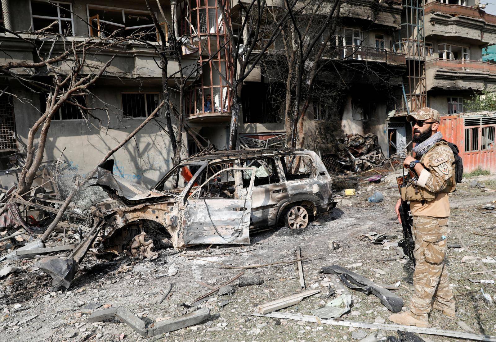 An Afghan security force personnel inspects the site of Sunday's attack in Kabul