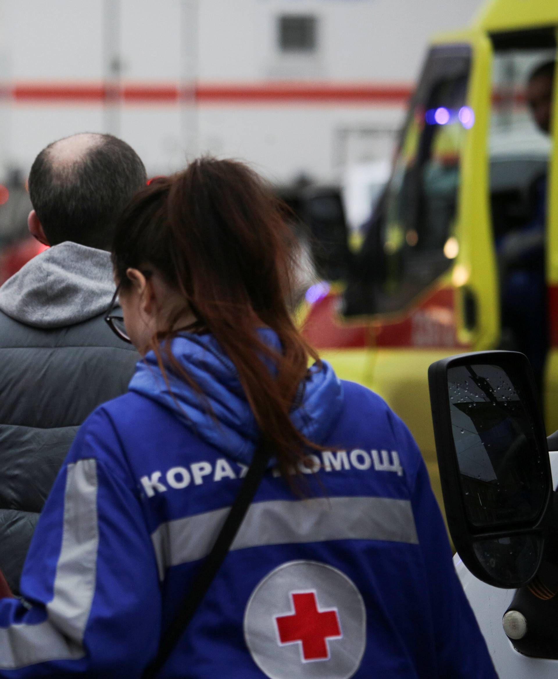 An injured person is helped by emergency services outside Sennaya Ploshchad metro station following explosions in St. Petersburg