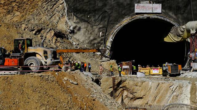 Heavy machinery moves outside a tunnel where 40 road workers are trapped after a portion of the tunnel collapsed in Uttarkashi