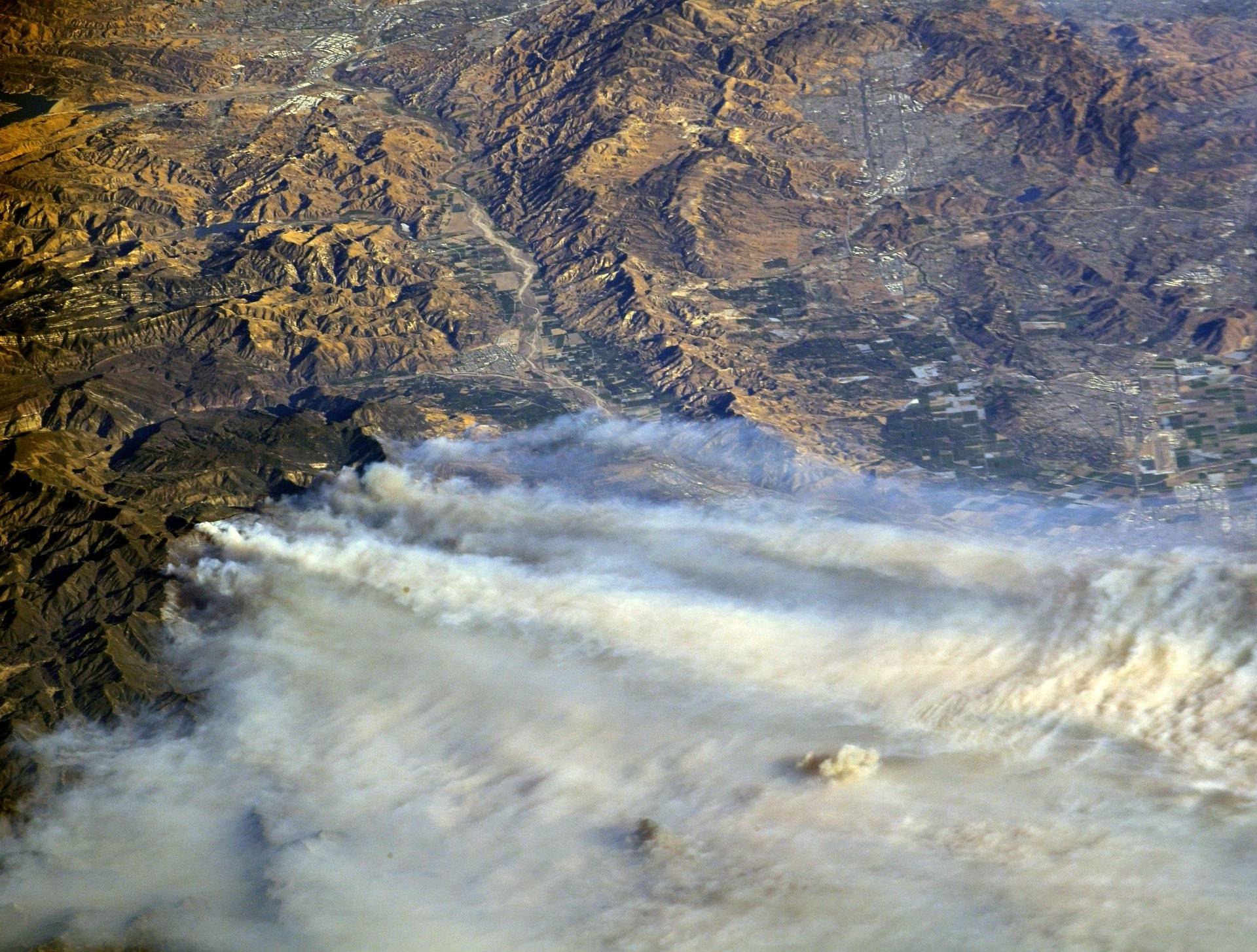 A photo taken from the International Space Station shows smoke rising from wildfire burning in Southern California
