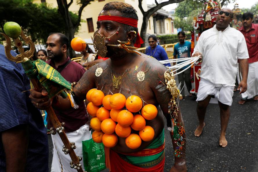 A devotee pulls a chariot during the Hindu festival of Thaipusam in Singapore