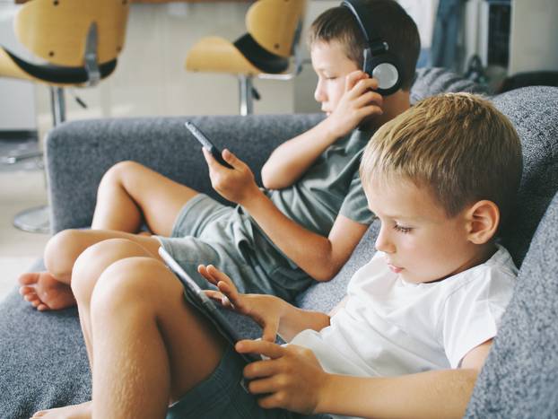 boys kids play tablet and phone. use technology