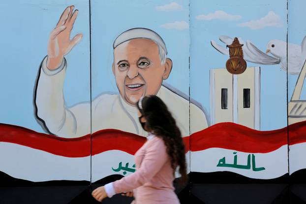 FILE PHOTO: A mural of Pope Franci  is seen on the wall of a church upon his upcoming visit to Iraq, in Baghdad