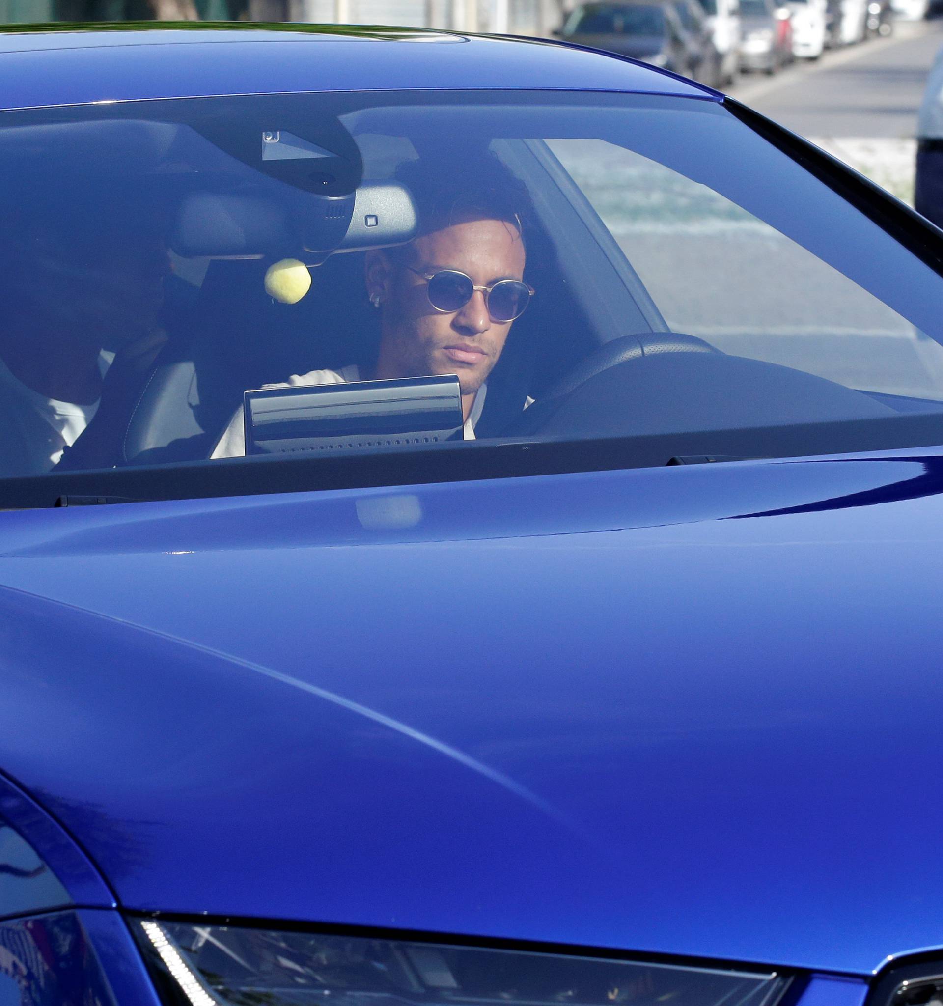 Brazilian soccer player Neymar drives to arrive to Joan Gamper training camp near Barcelona