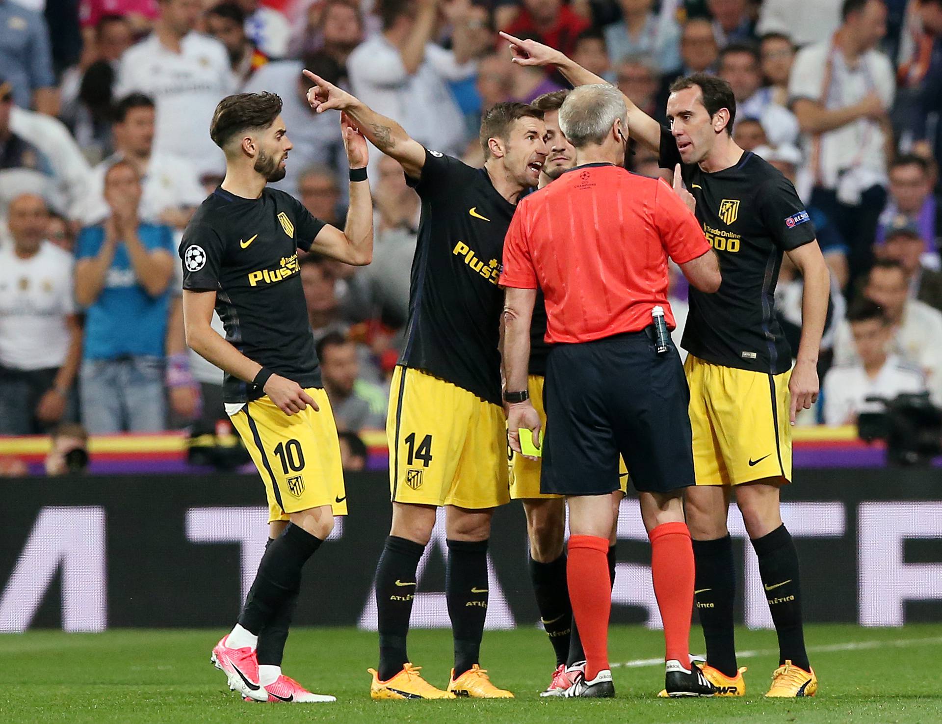 Atletico Madrid's Diego Godin and Gabi remonstrate with referee Martin Atkinson