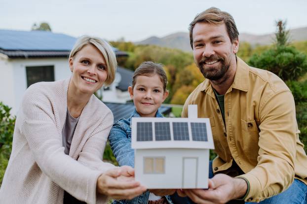 Happy,Family,Holding,Paper,Model,Of,House,With,Solar,Panels.alternative