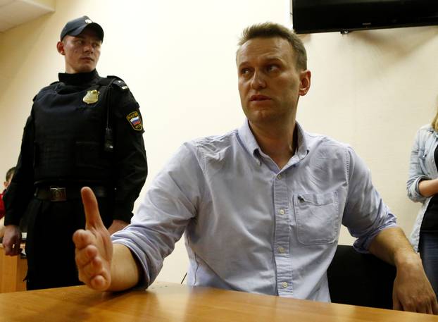 Russian opposition leader Navalny talks to journalists during a hearing at a court in Moscow