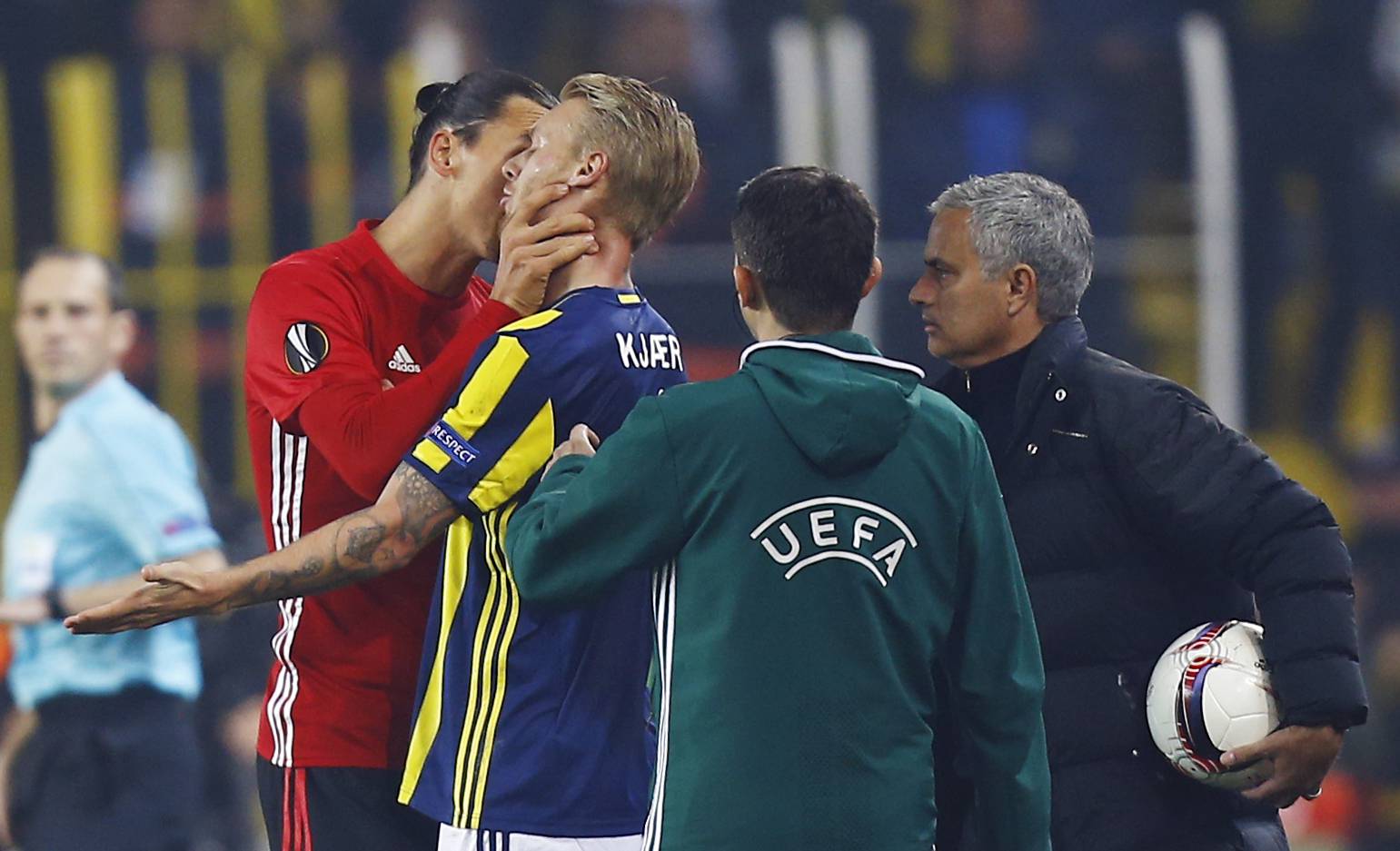 Manchester United's Zlatan Ibrahimovic clashes with Fenerbahce's Simon Kjaer as manager Jose Mourinho looks on