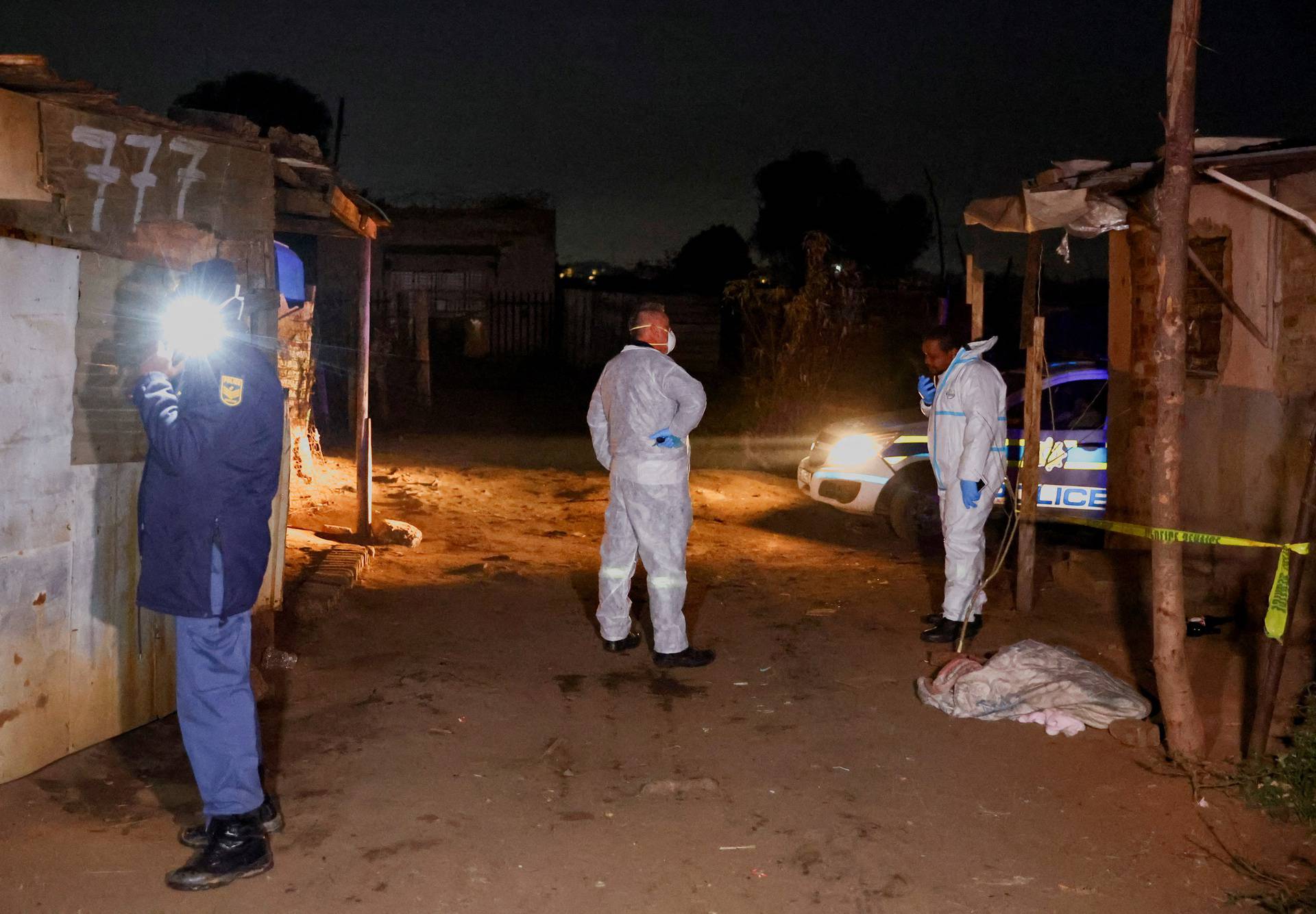 Police stand guard at the scene following a suspected gas leak thought to be linked to illegal mining