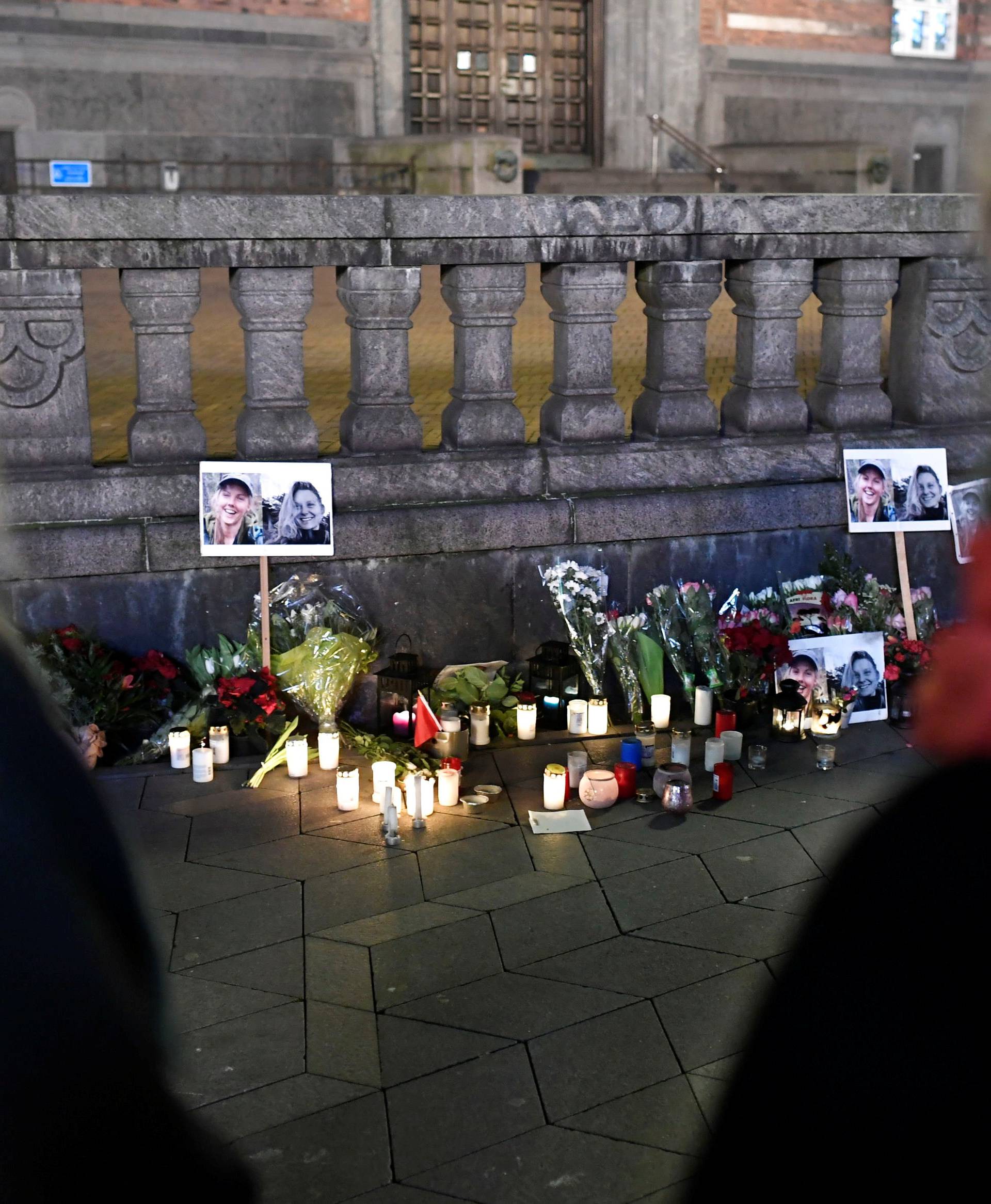 People bring flowers and light candles in memory of Louisa Vesterager Jespersen and Maren Ueland, in Copenhagen