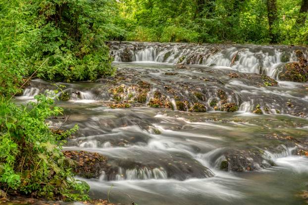 Turquoise color of water in the summer on the river Janj