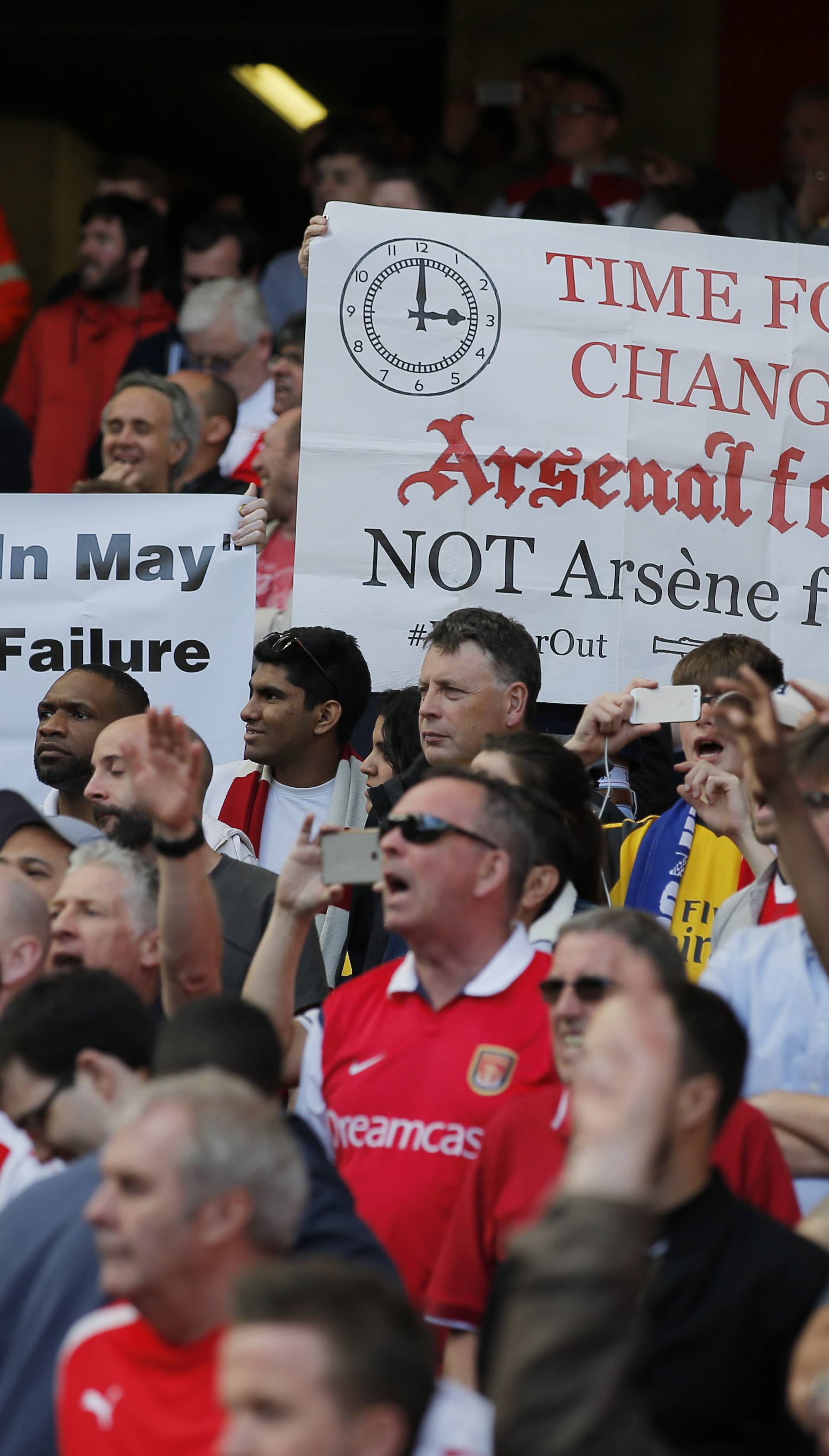 Arsenal fans hold up banners for manager Arsene Wenger