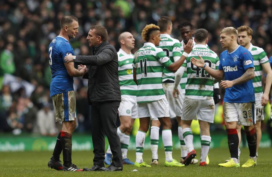 Celtic manager Brendan Rodgers with Rangers' Clint Hill after the match