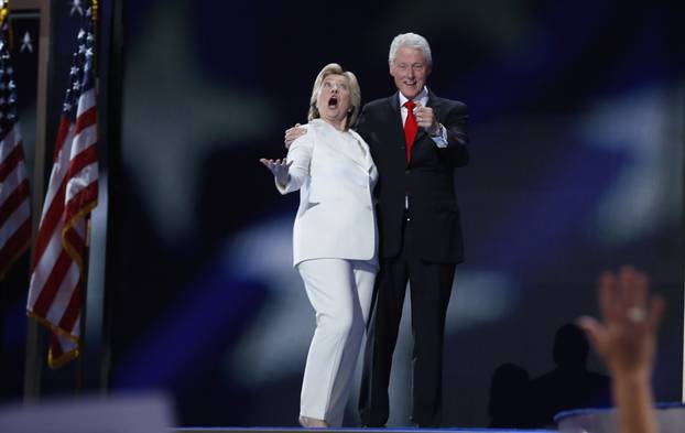 Democratic presidential nominee Hillary Clinton and her husband former president Bill Clinton react to the balloon drop after she accepted the nomination on the fourth and final night at the Democratic National Convention in Philadelphia