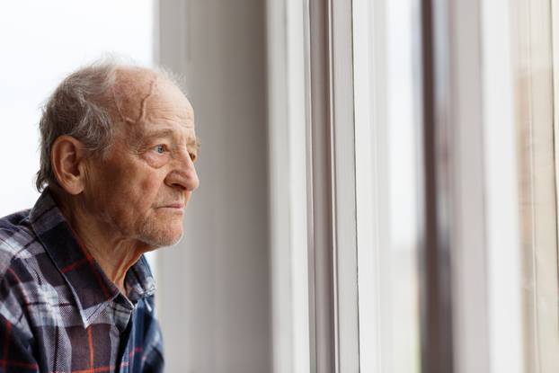 Portrait,Of,Elderly,Man,Looking,Out,Window