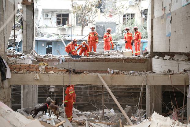 Rescue workers search for victims amid the debris following a gas pipeline explosion in Shiyan