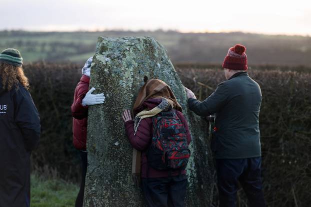 Revellers celebrate sunrise at the Newgrange stone age passage tomb