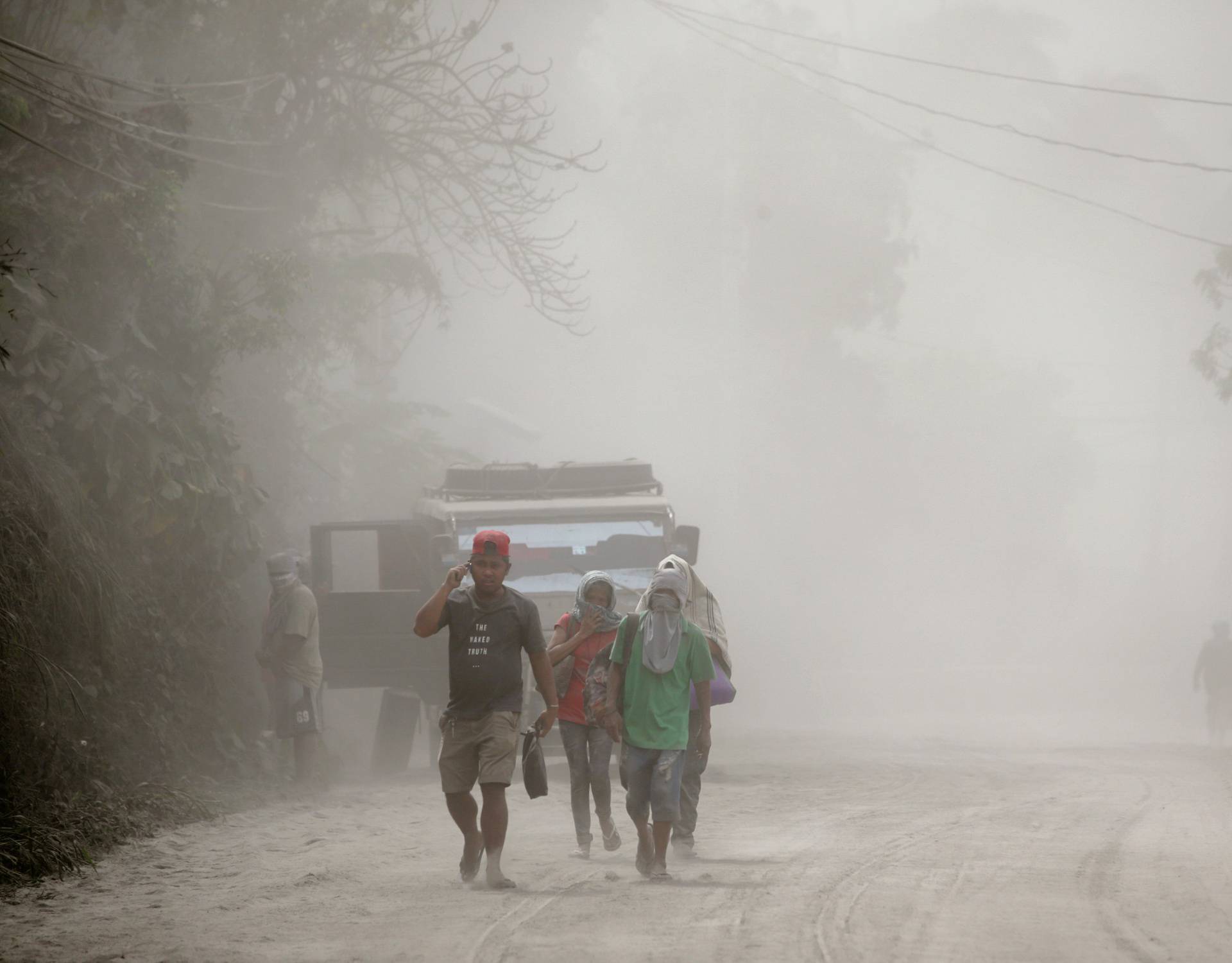 Residents living near the erupting Taal Volcano evacuate Agoncillo