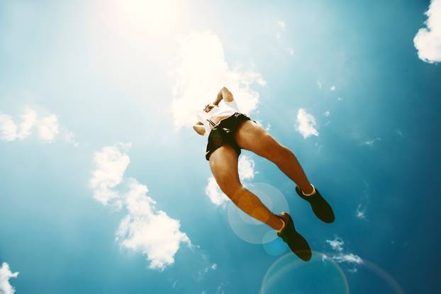 Young man jumping - fitness, sport, parkour, people concept.