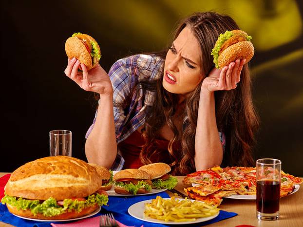 Girl eating big sandwich.