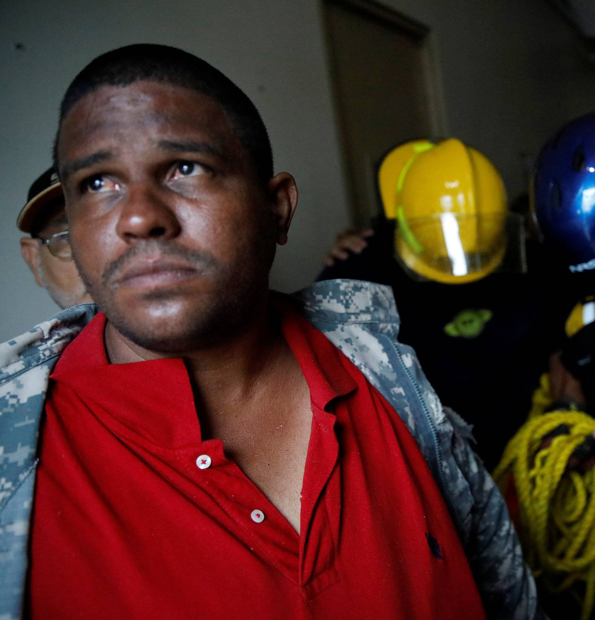 Rescue workers pray before walking out from the Emergency Operation Centre after the area was hit by Hurricane Maria in Guayama