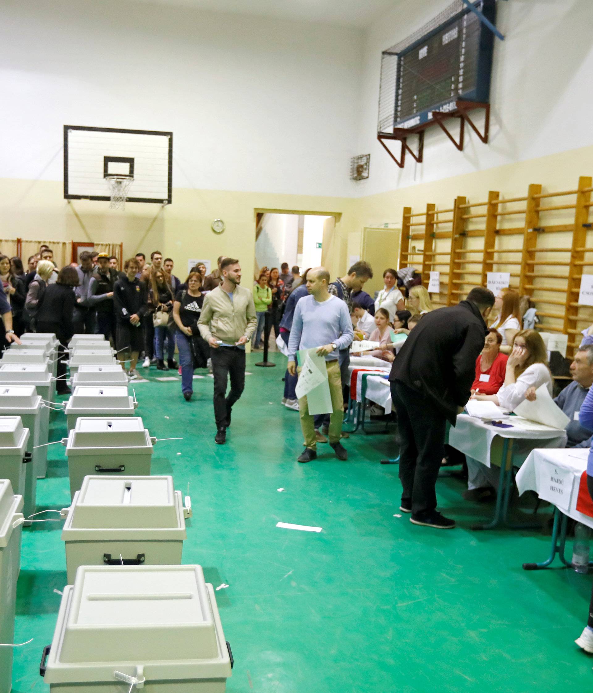 People vote during Hungarian parliamentary election after the official closing of the polling station in Budapest