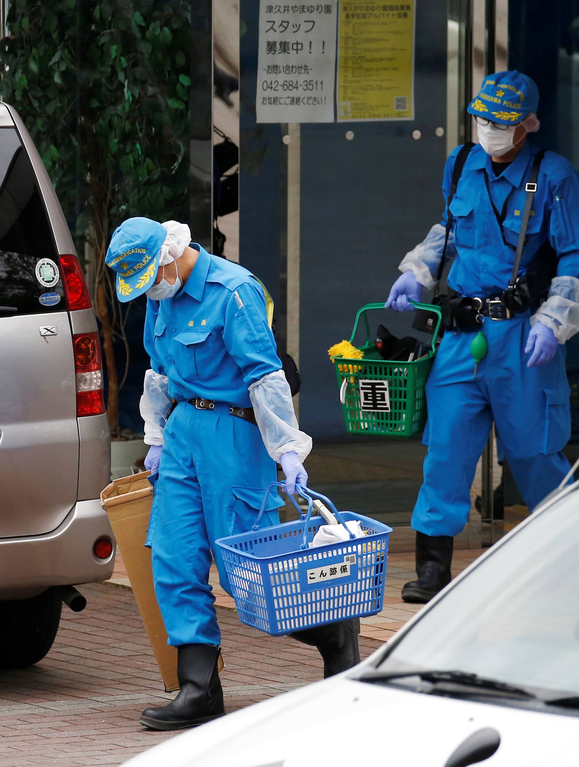 Police officers investigate at a facility for the disabled, where a deadly attack by a knife-wielding man took place, in Sagamihara, Kanagawa prefecture, Japan